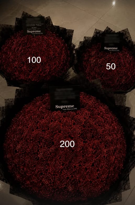 Three Supreme Luxe bouquets photographed together for scale: fifty, one hundred and two hundred roses